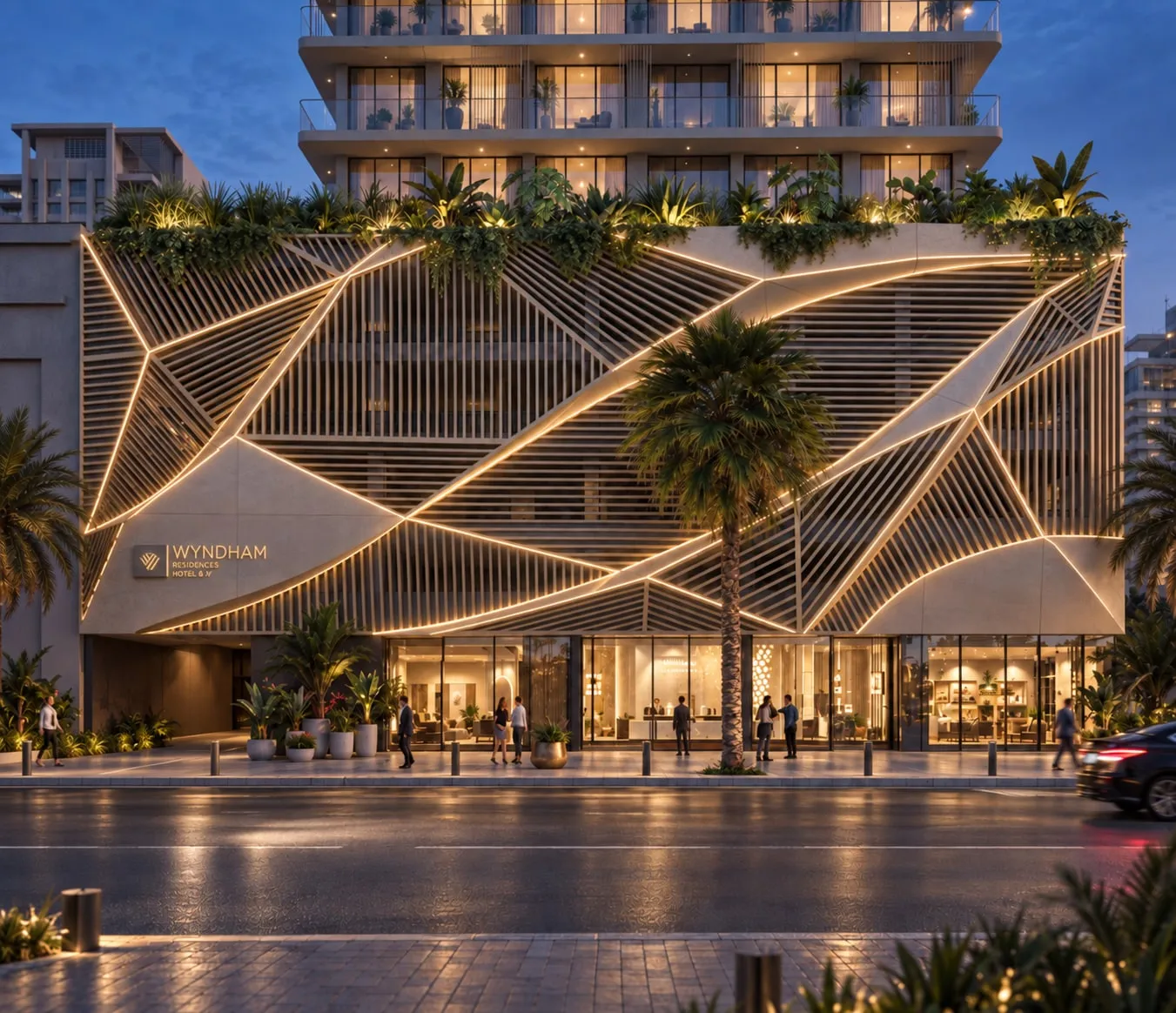 Wyndham Residences at dusk: a lit geometric lattice façade with planting along the roofline and a palm-lined street.